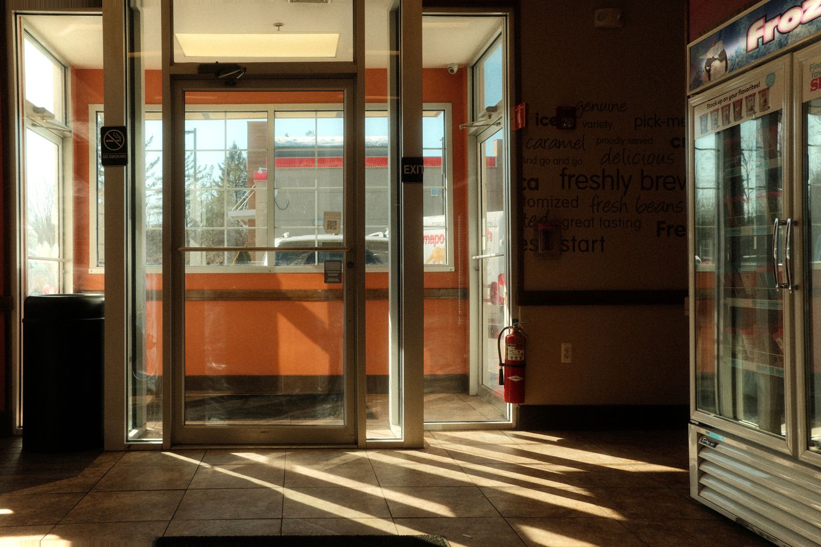 The sunlit entrance of a US convenience store