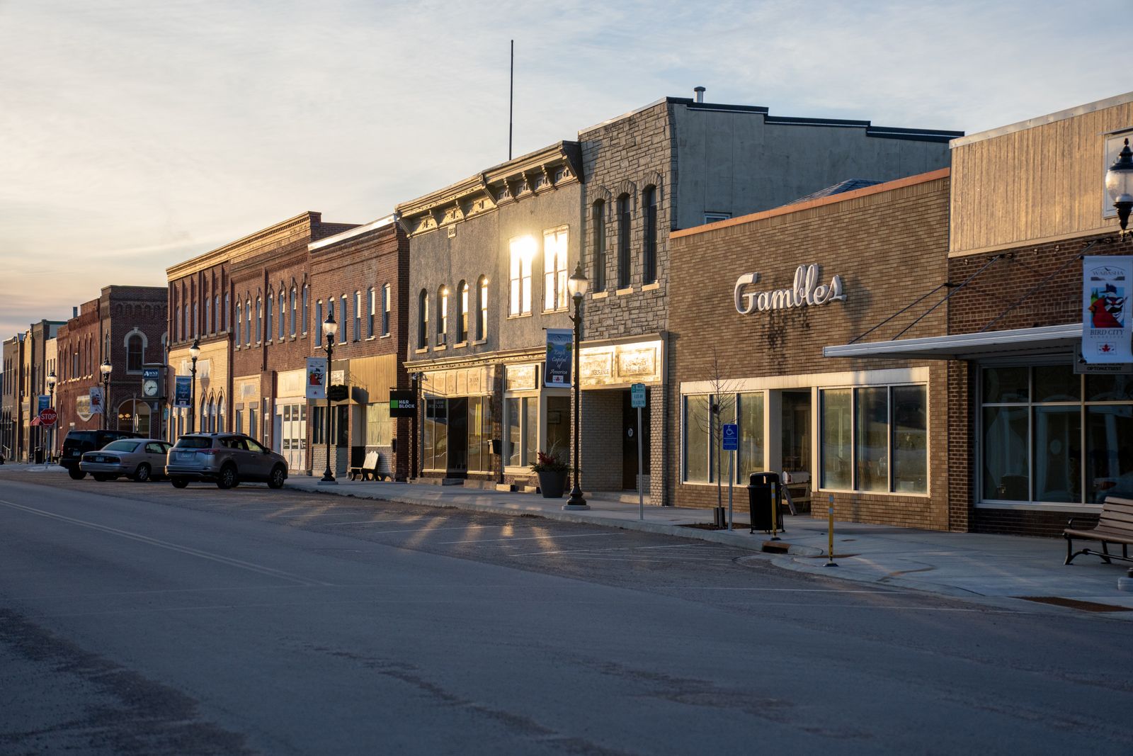Historic storefronts on the main street of a small US town at sunset
