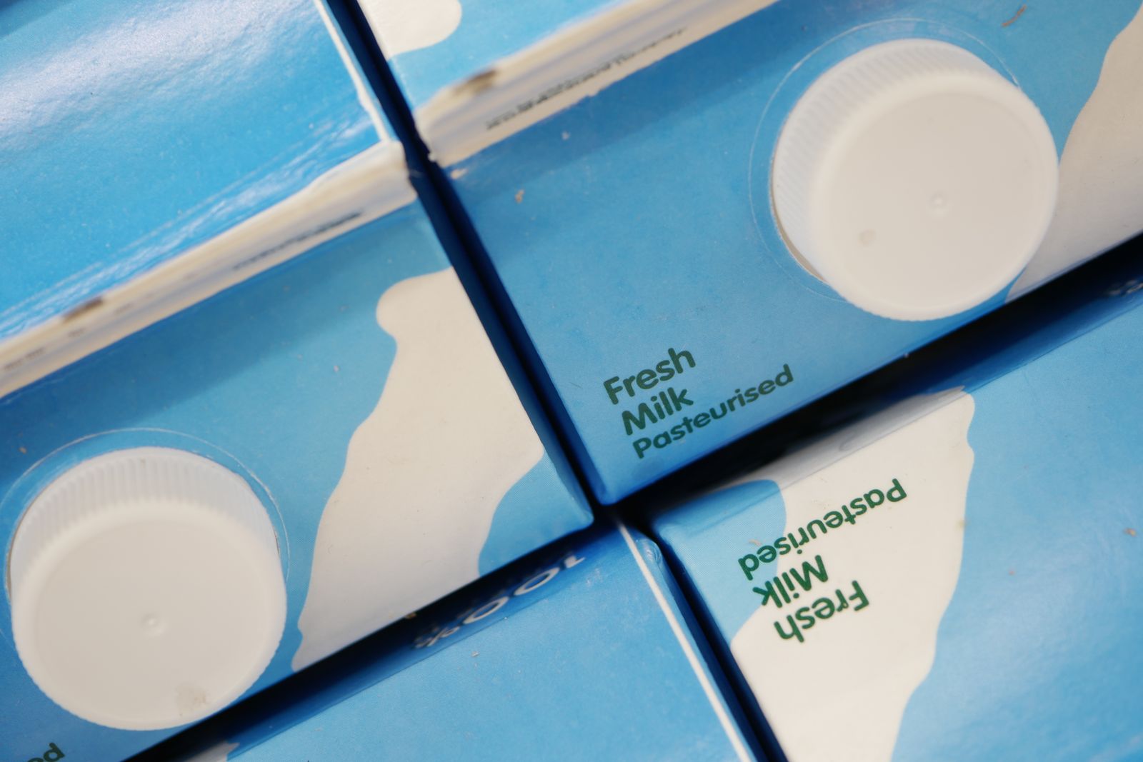 Sealed fresh milk cartons seen from above