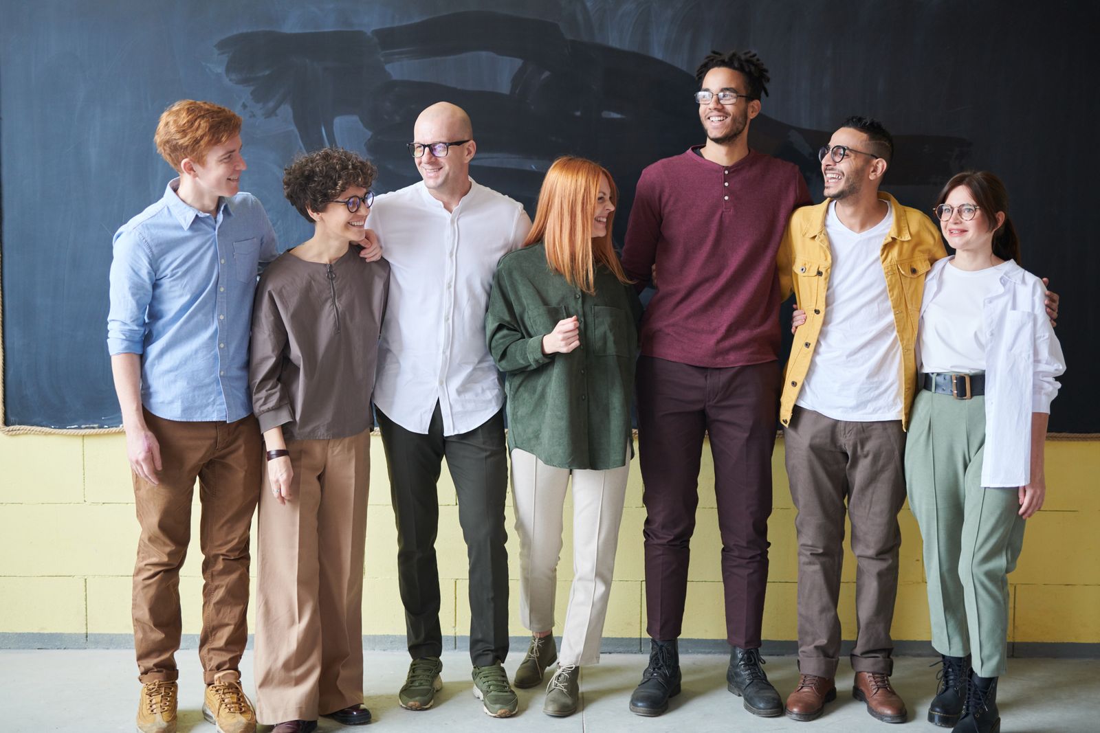 A diverse team of six standing together and smiling